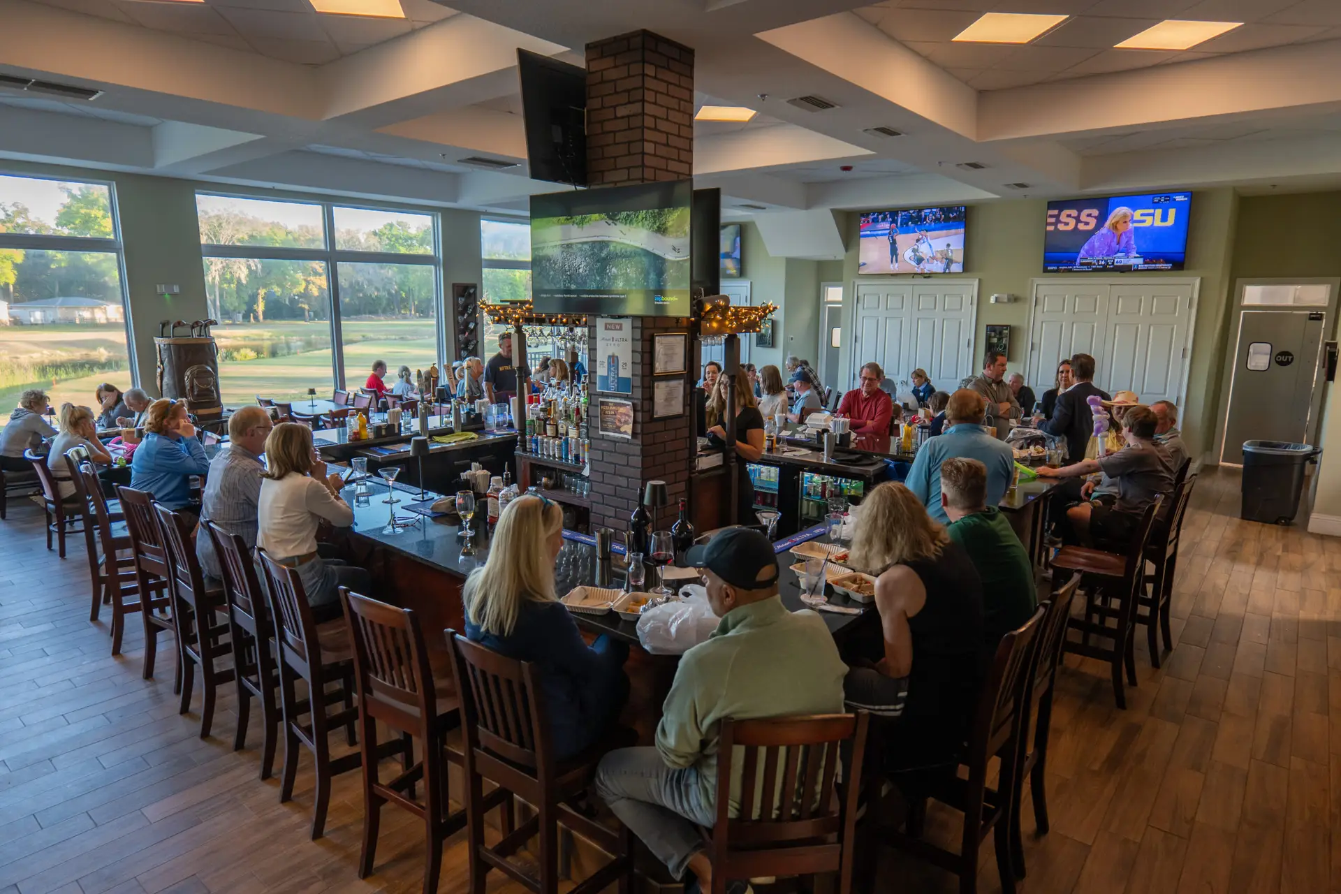 Members and guests dining in the Tuscan Lounge & Grill overlooking the course