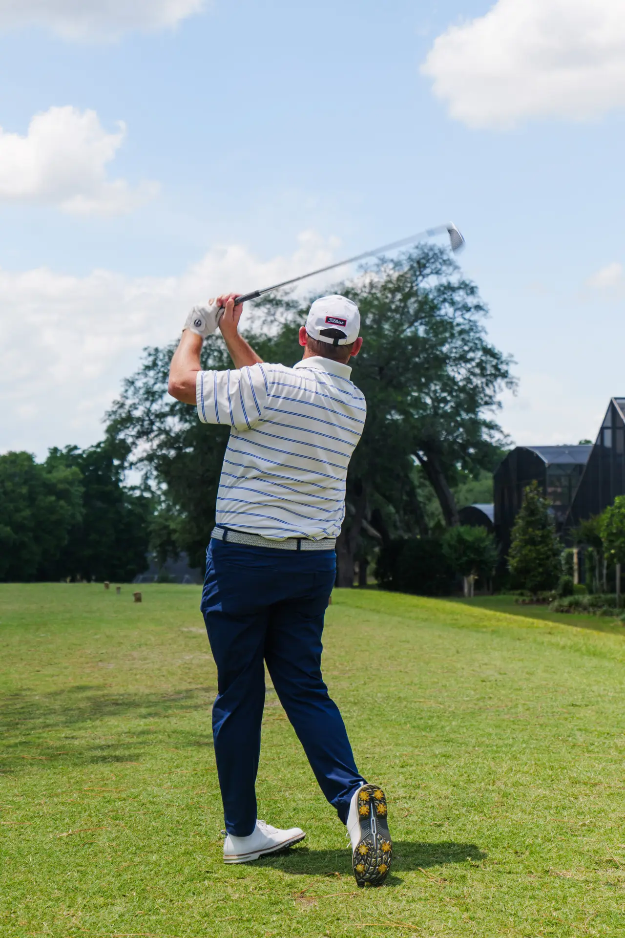 A golfer finishes his swing on the tee at Sweetwater