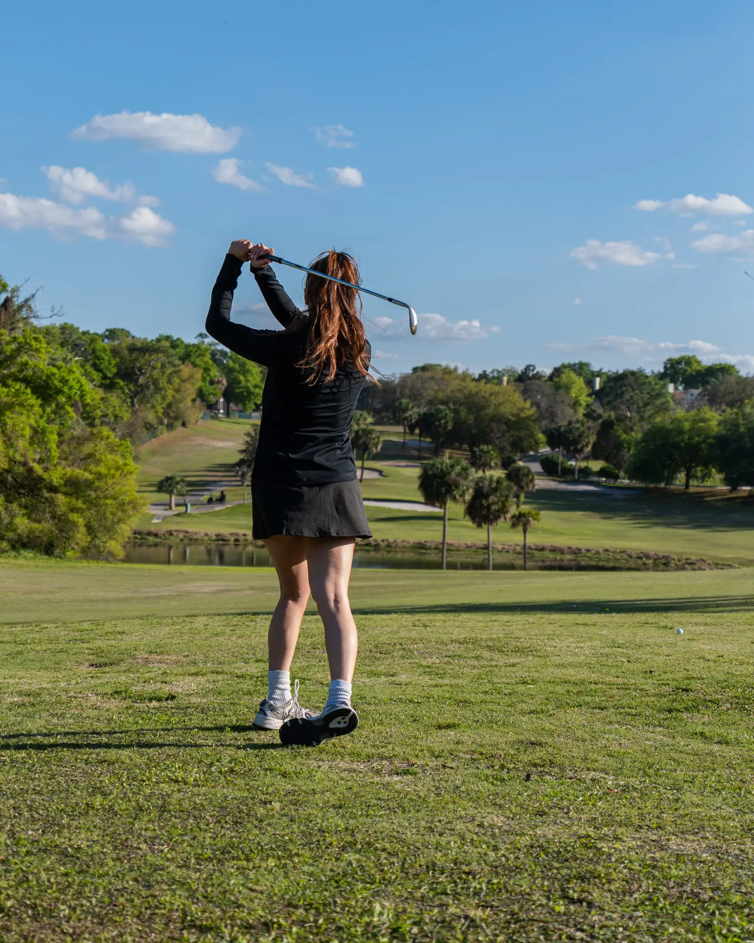 A golfer follows through on a tee shot at Sweetwater Golf & Country Club